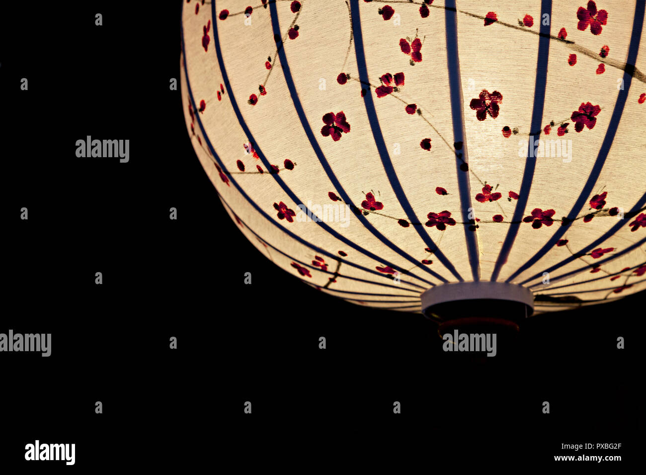 Close-up of white Chinese lantern over black background Stock Photo - Alamy
