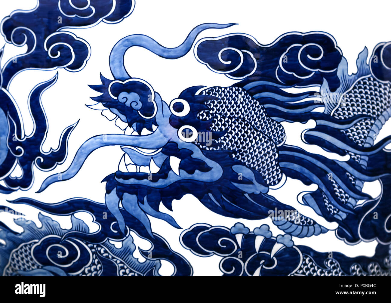 Chinese dragon painted on a ceramic vase with cobalt blue glaze Stock Photo
