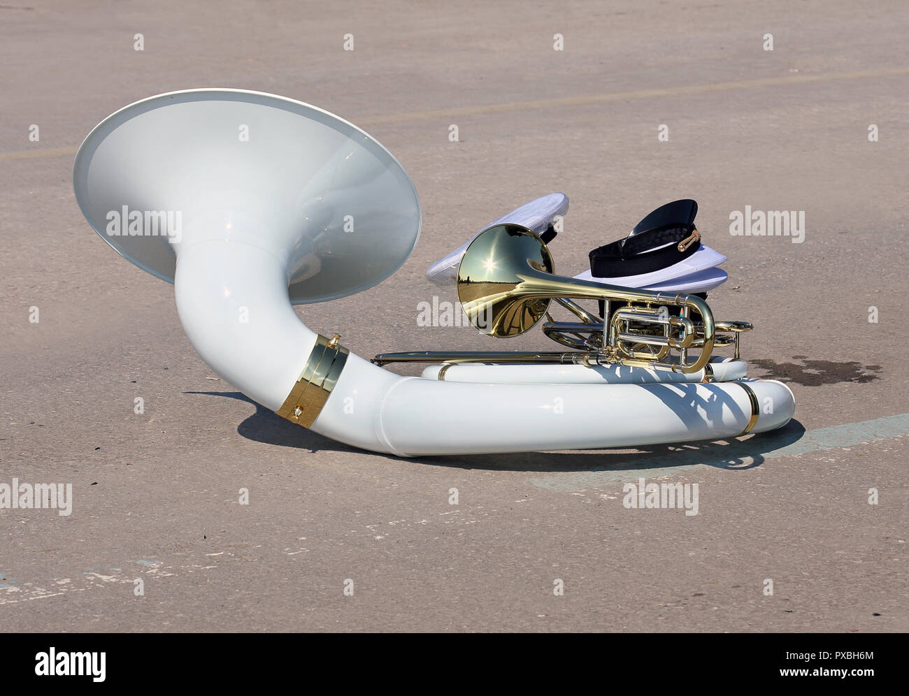 Wind instruments of military orchestra - sousafon and trumpet - on asphalt Stock Photo