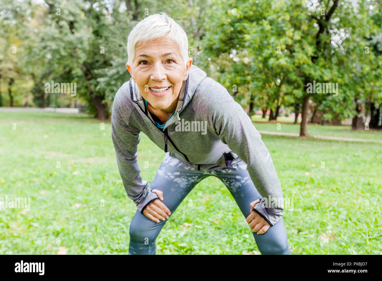 Mature Fit Woman In Sportswear Fitness Exercise In Nature, Workout Outdoor Stock Photo Alamy