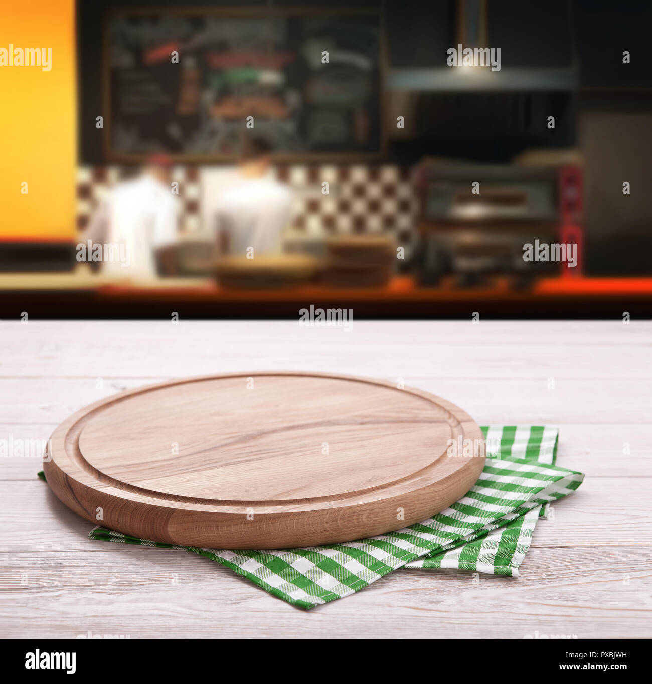 Empty Pizza Board With Tablecloth On The Table And Pizzeria