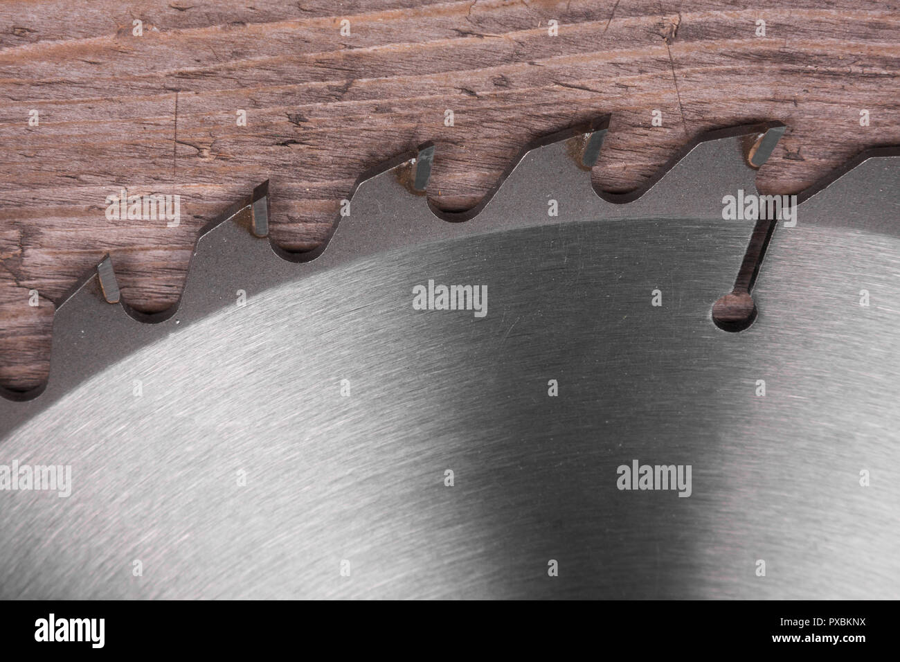Close-up, metal circular saw blade on a wooden background, top view Stock Photo