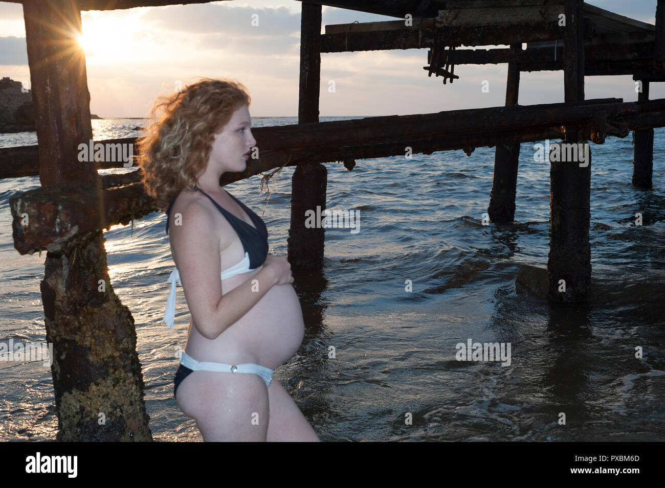 an amazing pregnancy woman with bikini at sea coast Stock Photo
