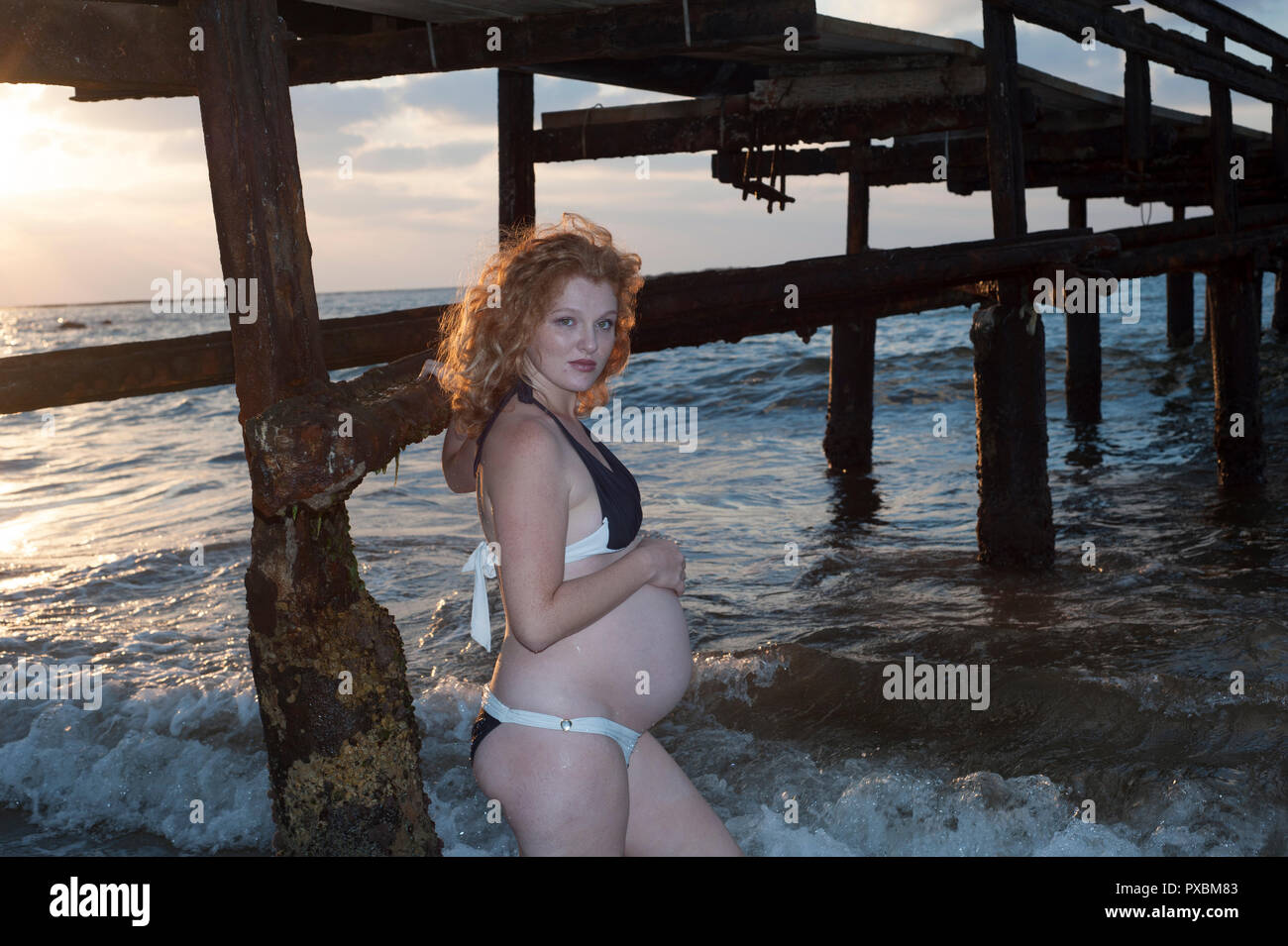 an amazing pregnancy woman with bikini at sea coast Stock Photo