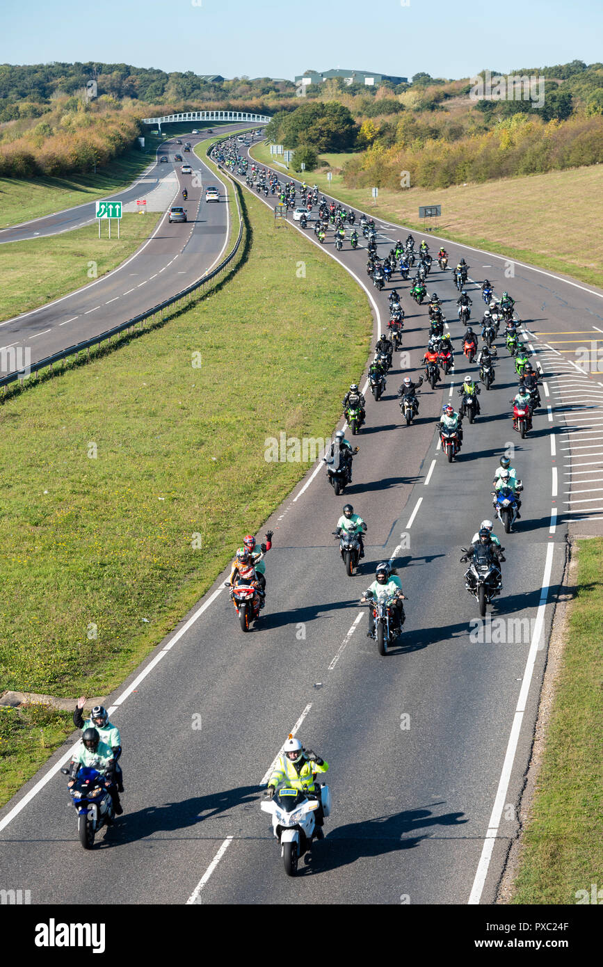 Memorial motorcycle ride for Liam Holding, 24, killed in a road accident whilst riding his motorbike on the A12 in Colchester, Essex. The family have asked for donations to Air Ambulance who attended scene but could not save him. Motorcyclists riding on A130 in tribute Stock Photo
