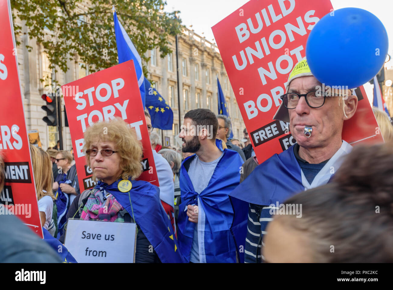 London, UK. 20th October 2018. Marchers walk past down Whitehall at the end of the People's Vote March calling for a vote to give the final say on the Brexit deal or failure to get a deal. They say the new evidence which has come out since the referendum makes it essential to get a new mandate from the people to leave the EU. With so many on the march the crowding meant many failed to reach Parliament Square and came to a halt in Whitehall. Peter Marshall/Alamy Live News Stock Photo
