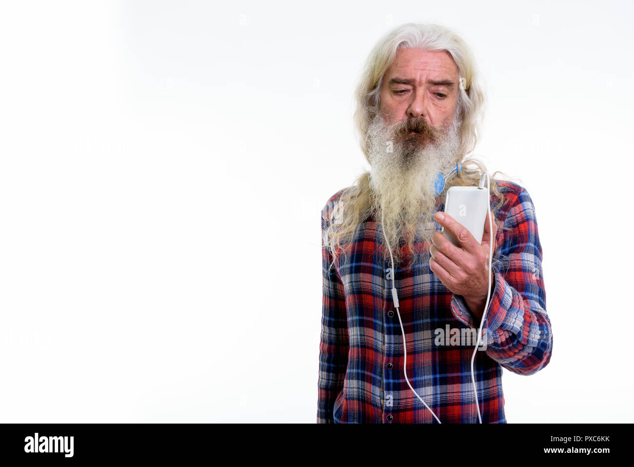 Studio shot of senior bearded man wearing headphones around neck Stock Photo