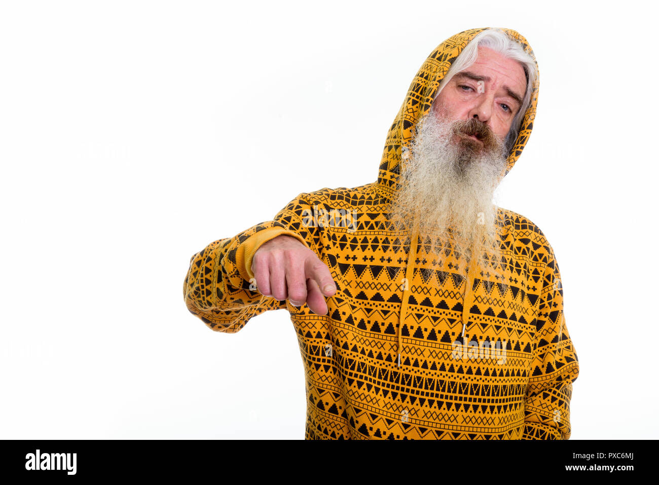Studio shot of senior bearded man wearing hoodie while pointing  Stock Photo