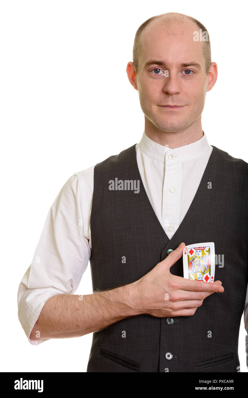 Bald Caucasian magician man bending Jack of Diamonds card Stock Photo