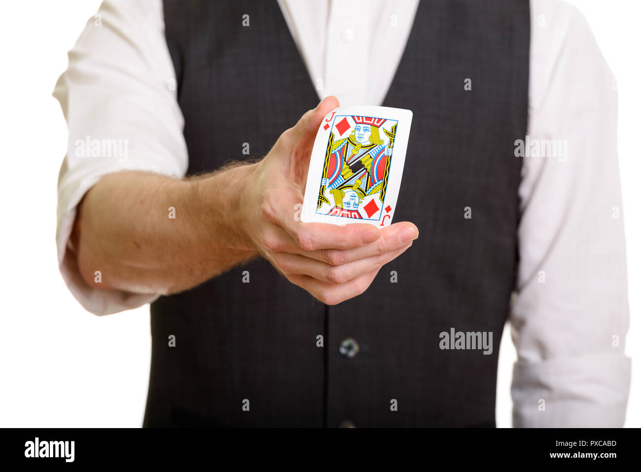 Caucasian magician man holding and bending Jack of Diamonds card Stock Photo