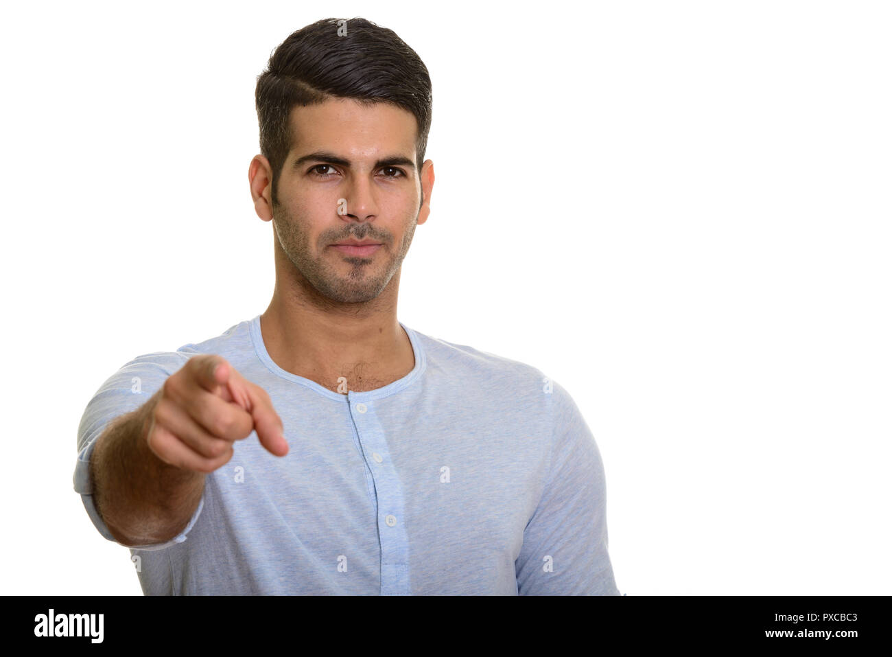 Young handsome Persian man pointing at camera Stock Photo