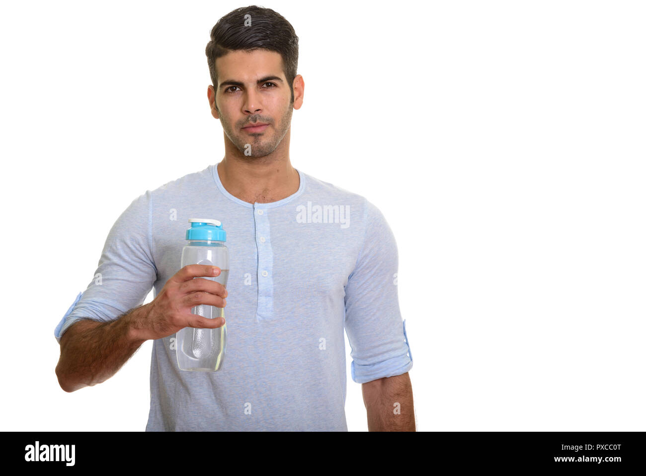 Young handsome Persian man holding water bottle Stock Photo - Alamy