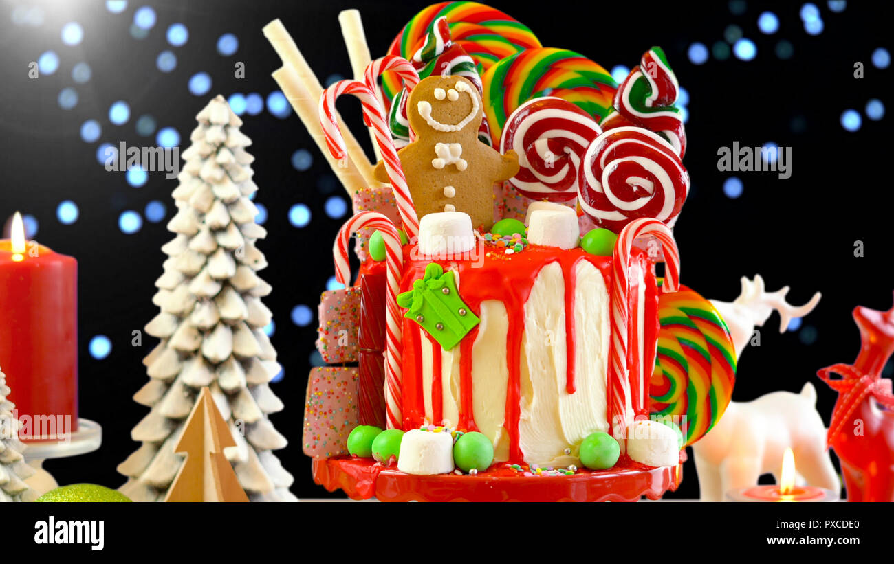 On trend candyland Christmas drip cake with Christmas lights bokeh