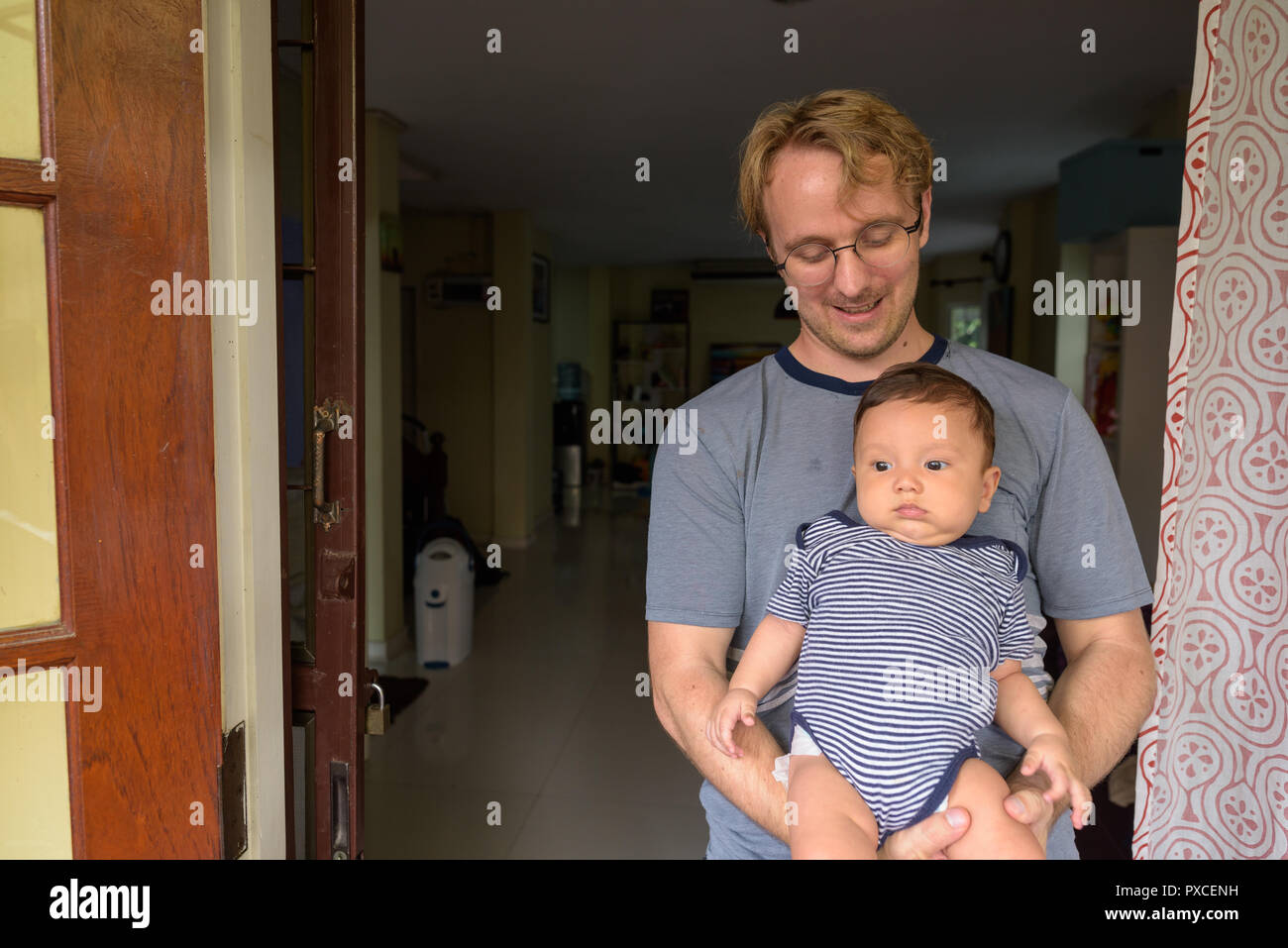 Father and baby son bonding together at home indoors Stock Photo