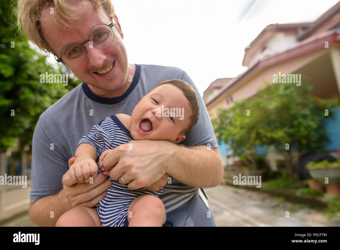 Father and baby son bonding together at home outdoors Stock Photo