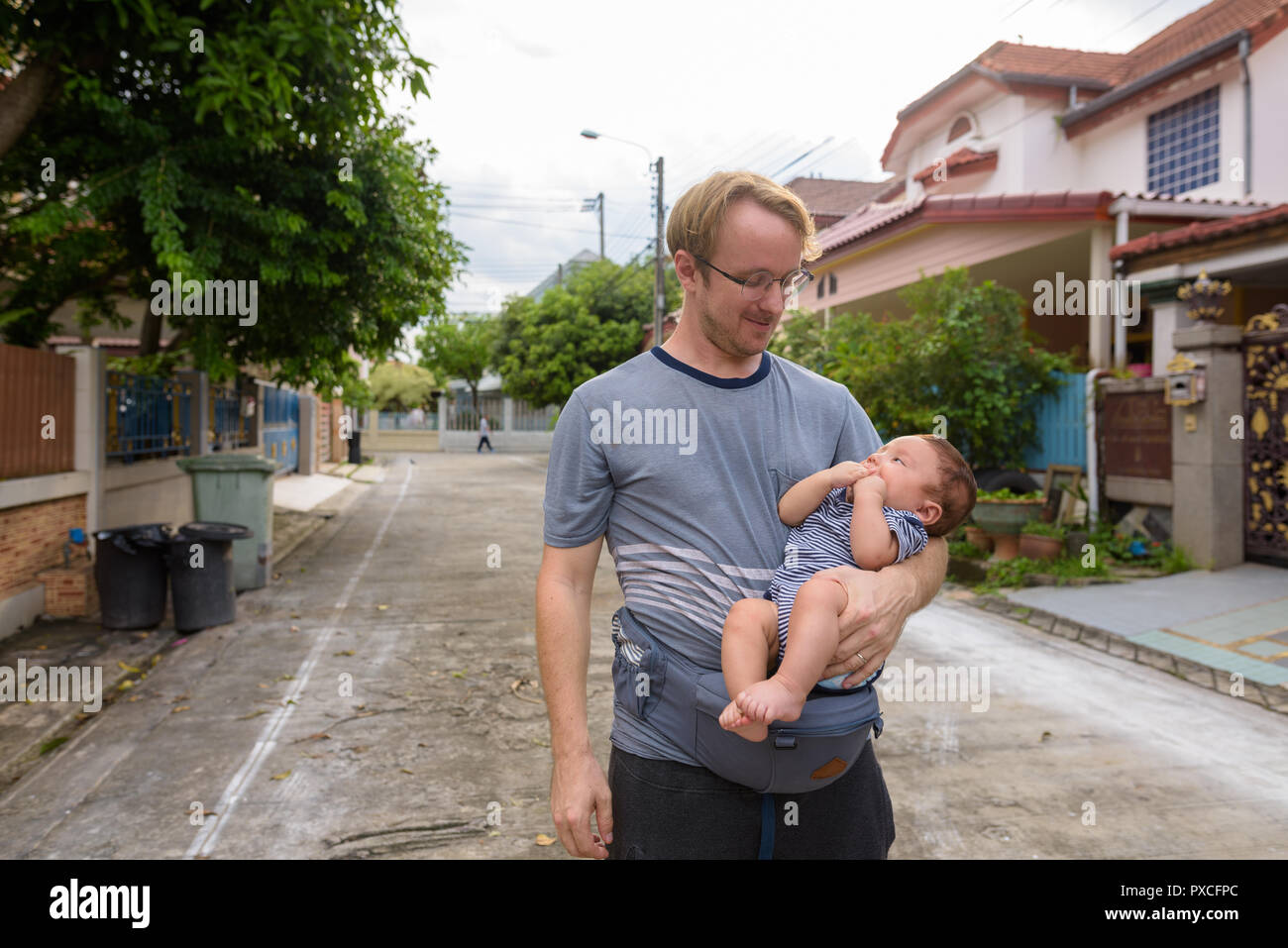 Father and baby son bonding together at home outdoors Stock Photo