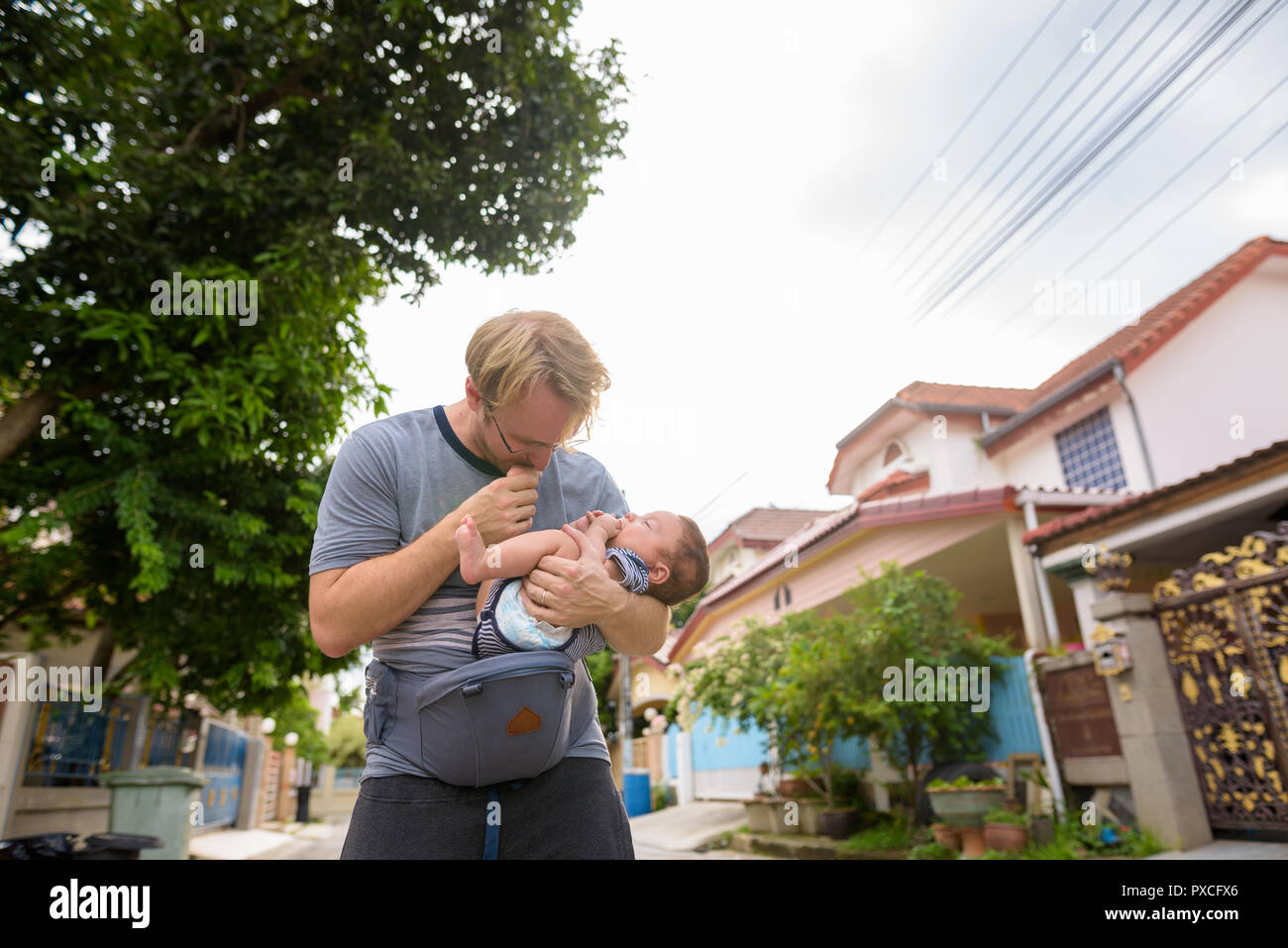 Father and baby son bonding together at home outdoors Stock Photo