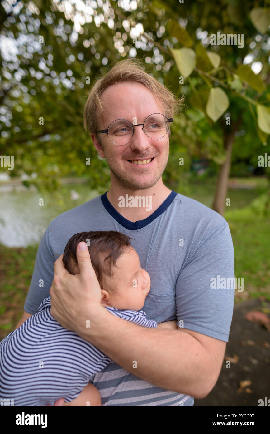Father and baby son bonding together at the park Stock Photo