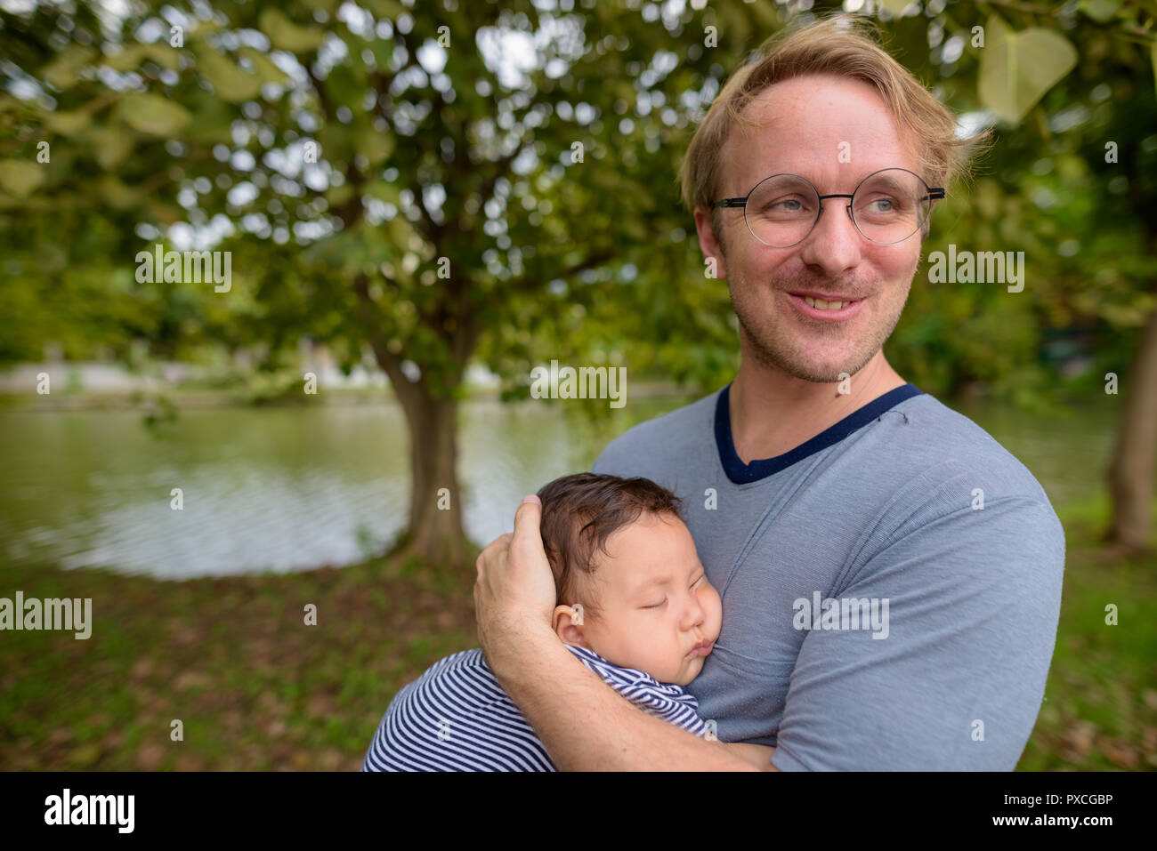 Father and baby son bonding together at the park Stock Photo