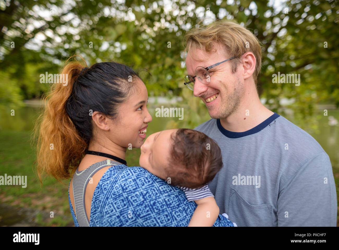 Multi-ethnic young family bonding together at the park Stock Photo