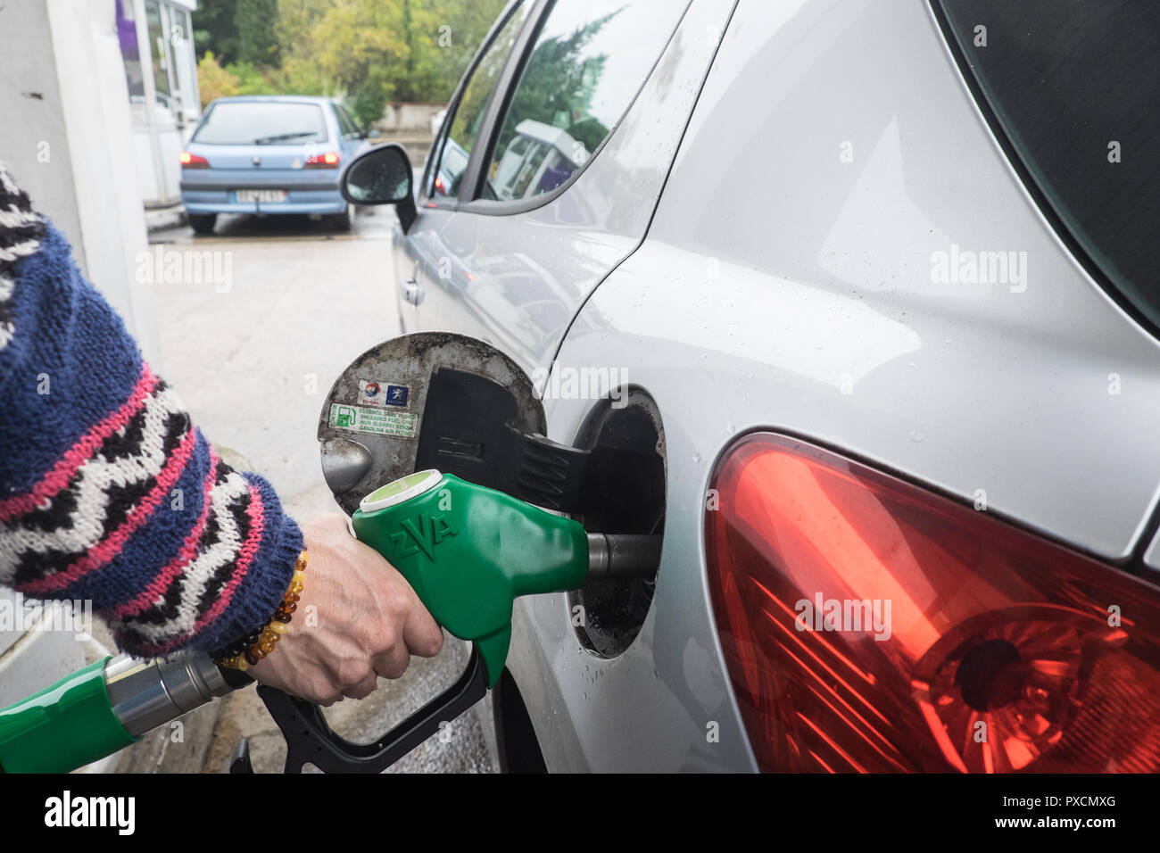 Putting,petrol,diesel,gasoline,self,service,into,Peugeot,car,at,petrol,gas,station,garage,in,Limoux,Aude,department,South,of, France,Europe,European, Stock Photo