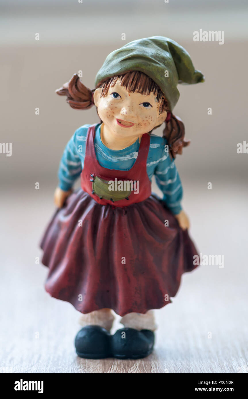 Close-up of a garden gnome on a wooden table Stock Photo - Alamy
