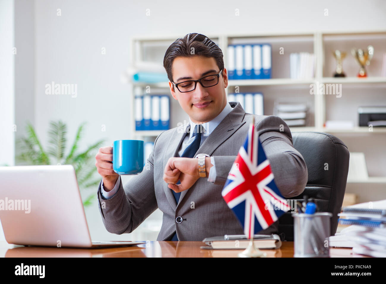 Businessman with British flag in the office Stock Photo - Alamy