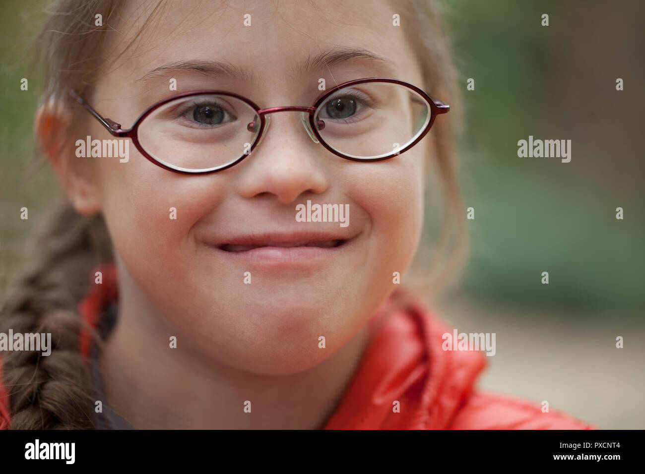 Portrait of a girl with special needs in glasses close-up in nature Stock Photo