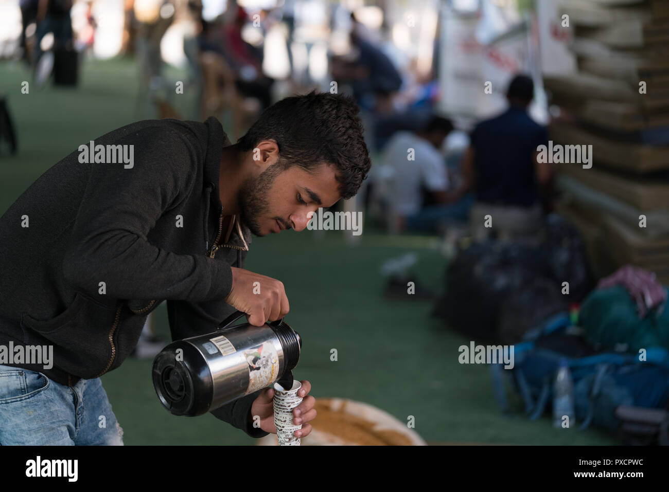 A man pours out coffee for the protestors in Khan al-Ahmar, West Bank Stock Photo