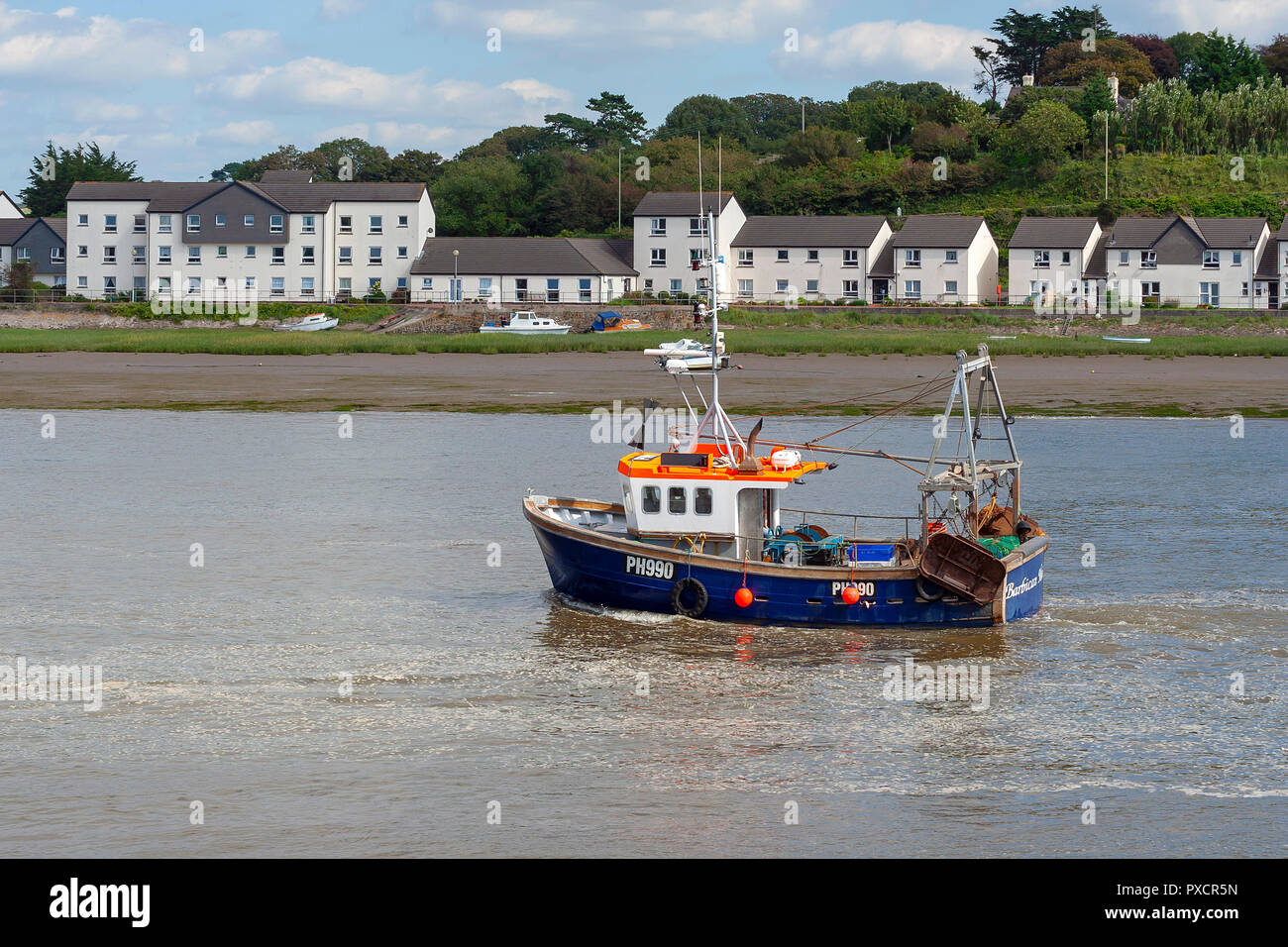 Bideford, Devon, UK - August 26, 2007: Small fishing boat travelling along the river Torridge on a cloudy summer day in Bidford North Devon Stock Photo