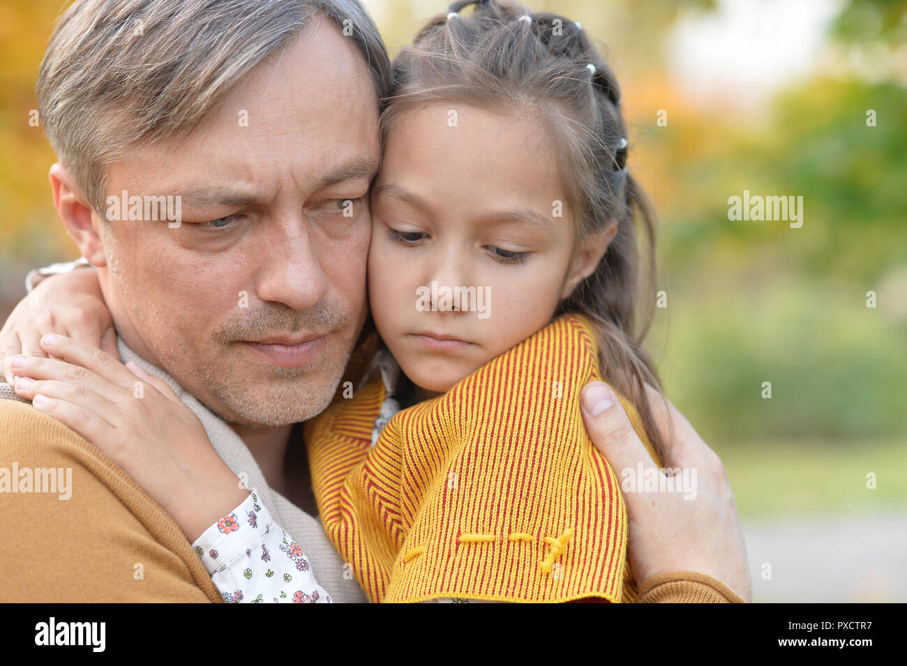 Portrait of father and daughter outdoors in autumn park Stock Photo