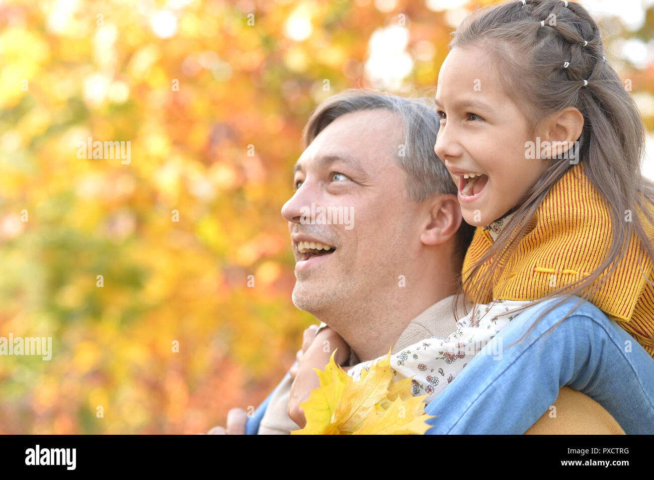 Portrait of father and daughter having fun in autumn park Stock Photo