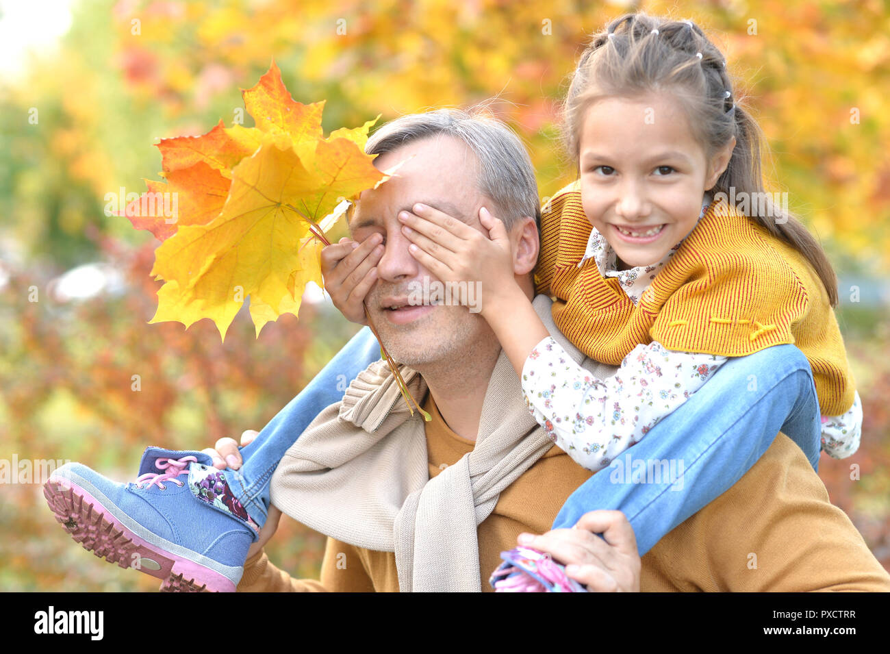 Portrait of father and daughter having fun in autumn park Stock Photo