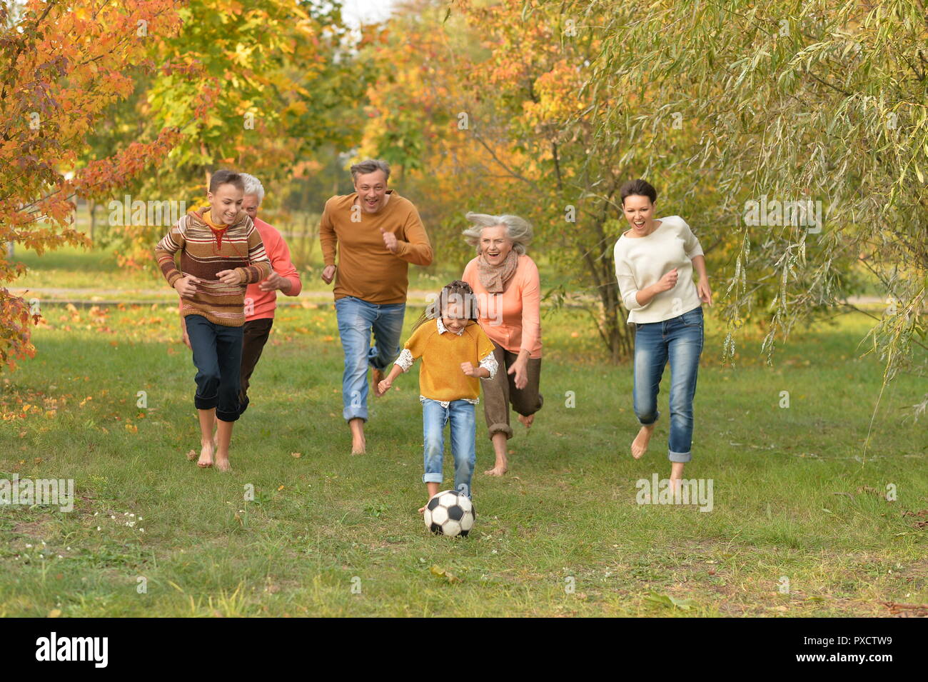 Portrait of big happy family playing football in park Stock Photo - Alamy