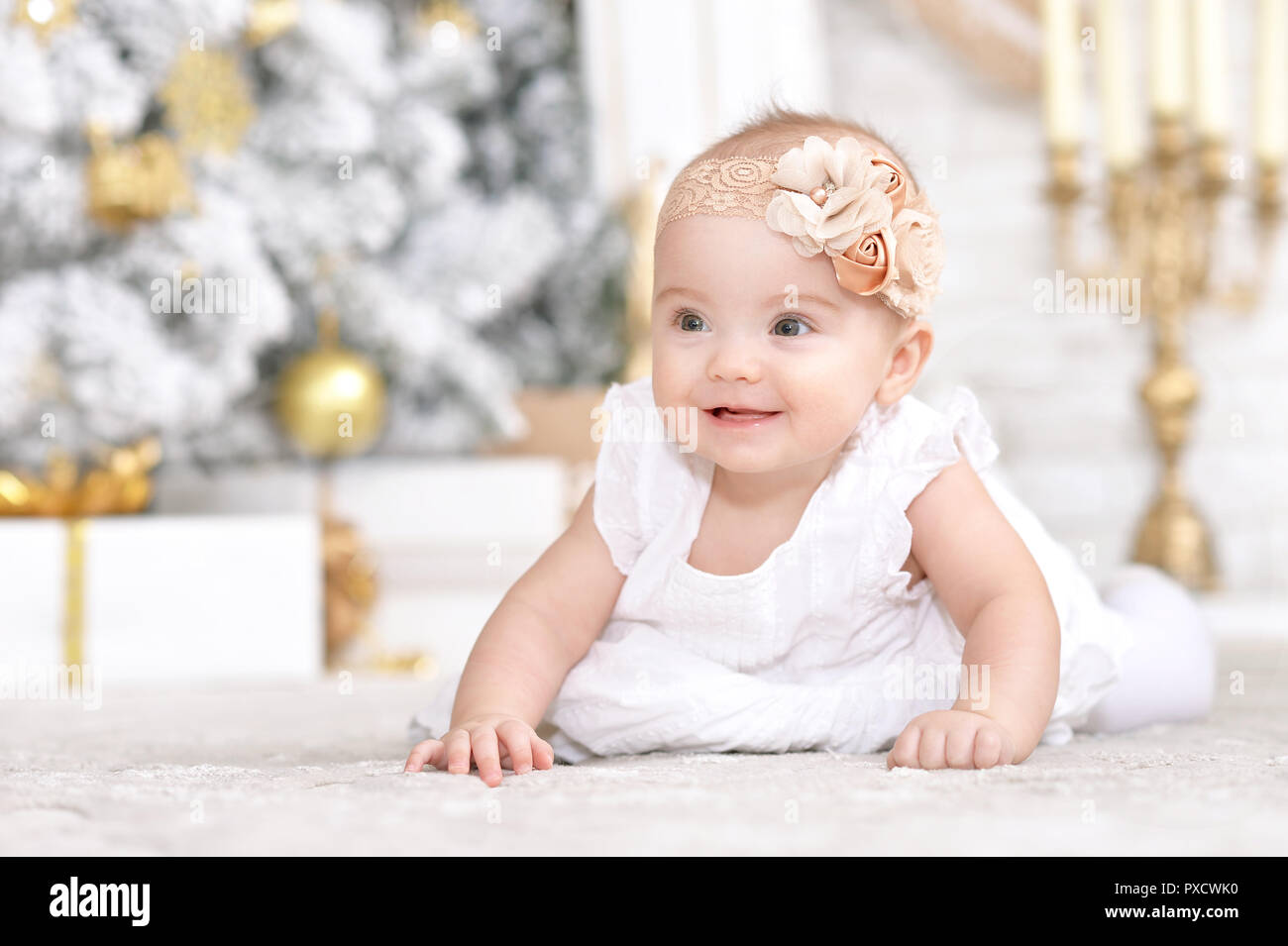 Portrait of cute baby girl on Christmas background Stock Photo
