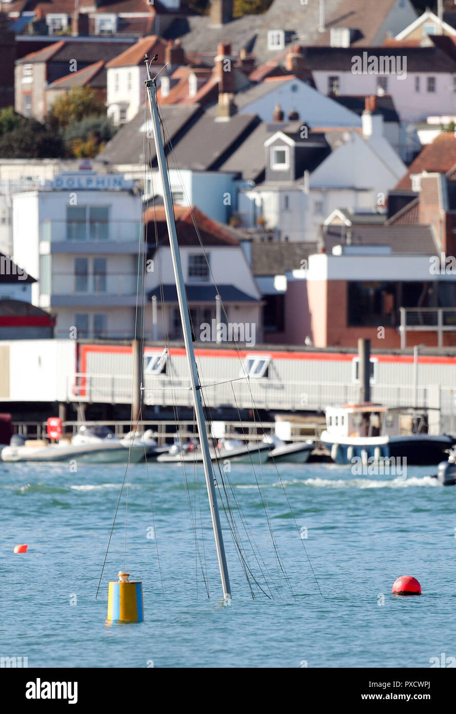 The mast of a submerged yacht in Cowes harbour on the Isle of Wight after it was involved in an incident with the Red Funnel car ferry, Red Falcon, which collided with several small boats due to bad weather. Stock Photo