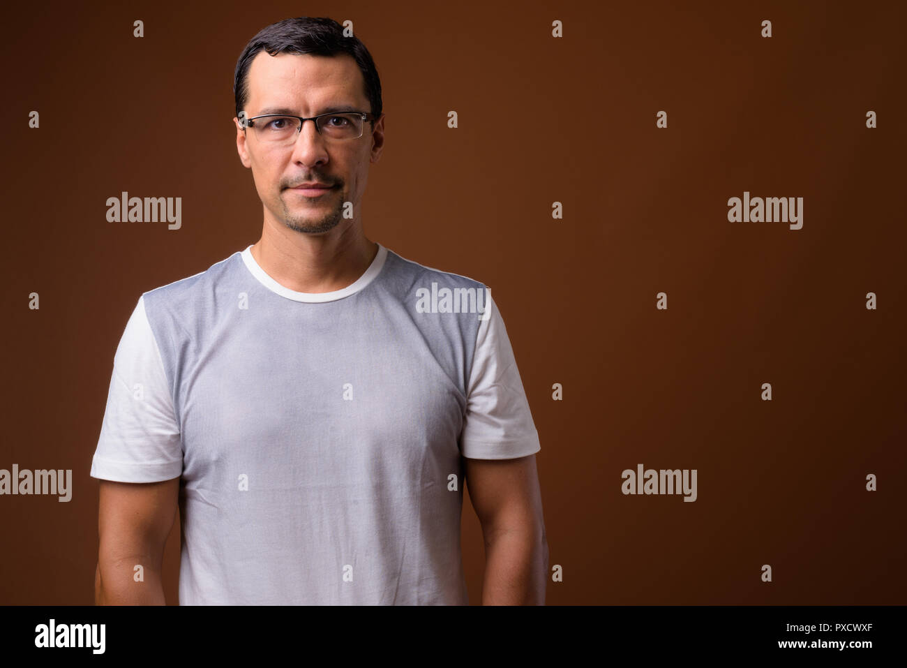 Portrait of handsome man against brown background Stock Photo