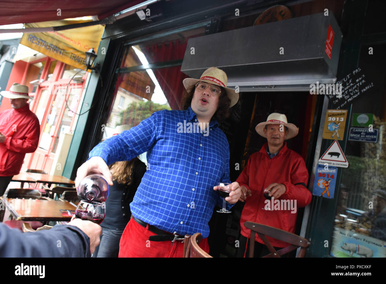 November 19, 2015 - Paris, France: Parisians celebrate the arrival of Beaujolais nouveau, a young red wine whose annual release every third Thursday of November is greeted by widespread degustation. Despite the recent Paris terror attacks, the owner of the bar 'Au Doux Raisin', Charles Alban (red pants) said he wanted to carry on the tradition and celebrate. Wine makers wearing red jackets and black armbands joined the party. The celebration comes as French authorities announced the death of terrorist mastermind Abdelhamid Abaaoud.  Des Francais fetent l'arrivee du Beaujolais Nouveau quelques  Stock Photo