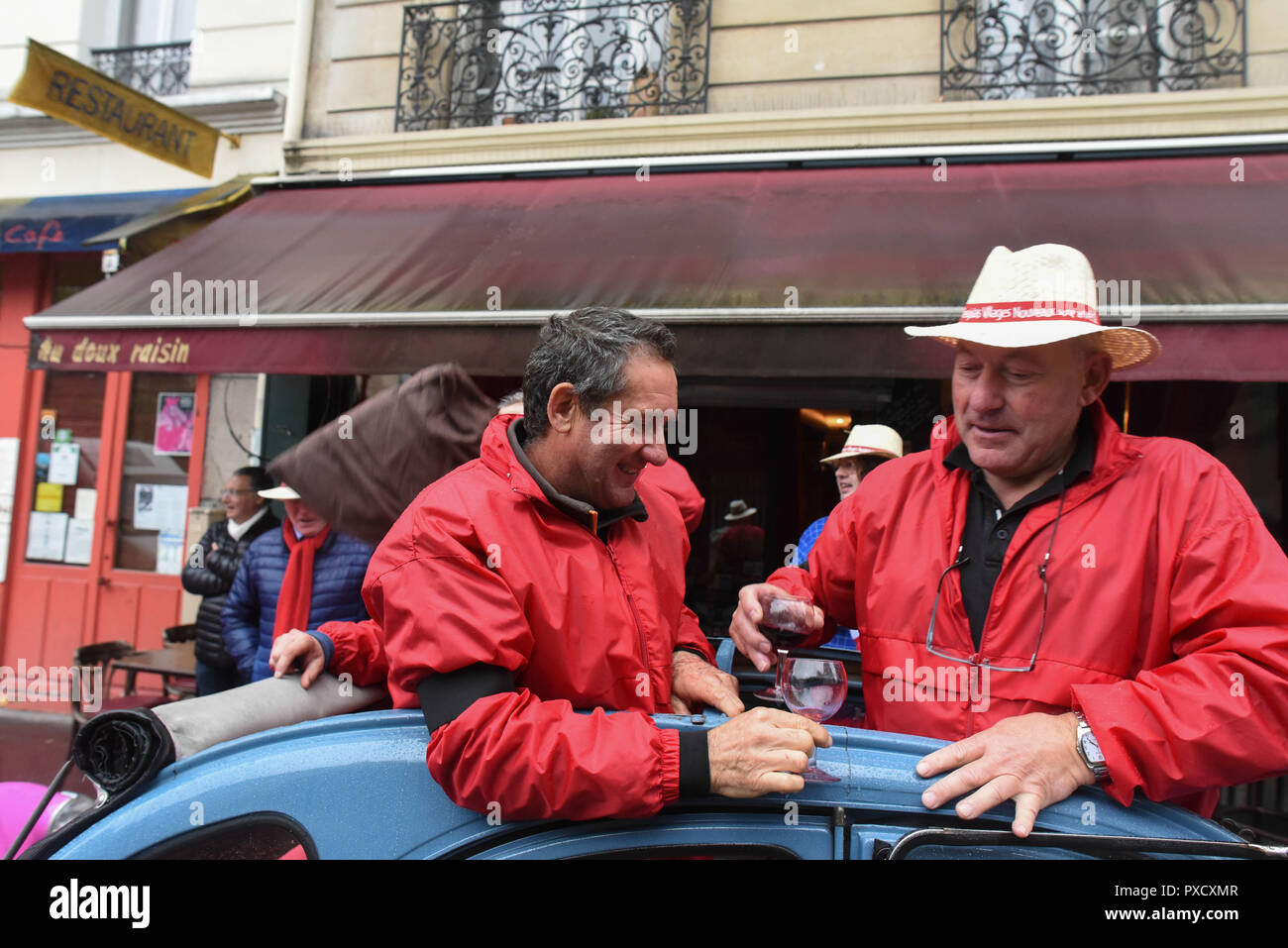 November 19, 2015 - Paris, France: Parisians celebrate the arrival of Beaujolais nouveau, a young red wine whose annual release every third Thursday of November is greeted by widespread degustation. Despite the recent Paris terror attacks, the owner of the bar 'Au Doux Raisin', Charles Alban (red pants) said he wanted to carry on the tradition and celebrate. Wine makers wearing red jackets and black armbands joined the party. The celebration comes as French authorities announced the death of terrorist mastermind Abdelhamid Abaaoud.  Des Francais fetent l'arrivee du Beaujolais Nouveau quelques  Stock Photo