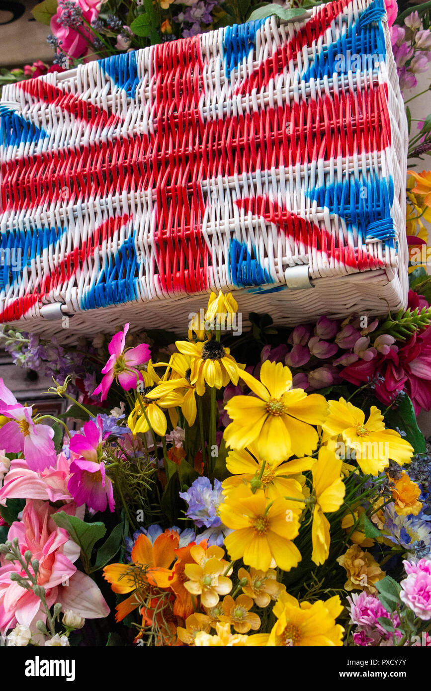 Union flag hampers amongst brightly coloured flowers in the summer Stock Photo