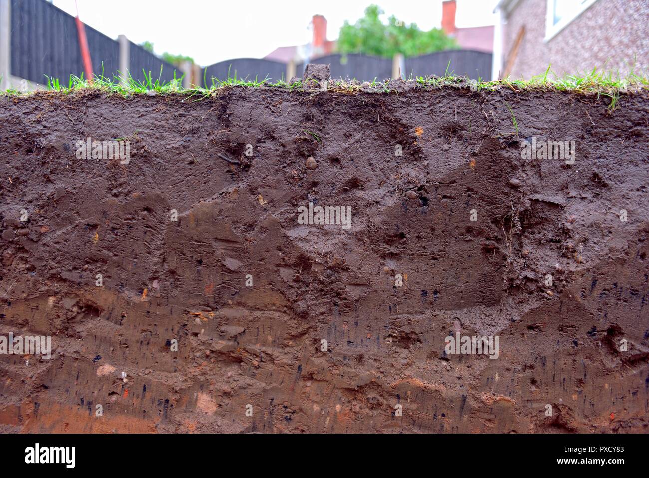 Layers of soil in a domestic garden in the UK Stock Photo