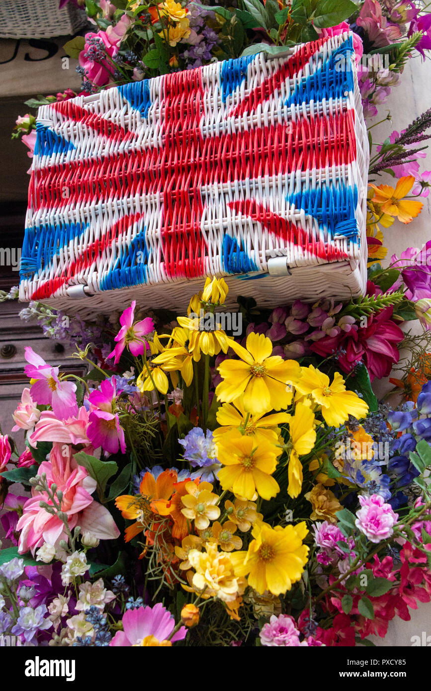 Union flag hampers amongst brightly coloured flowers in the summer Stock Photo