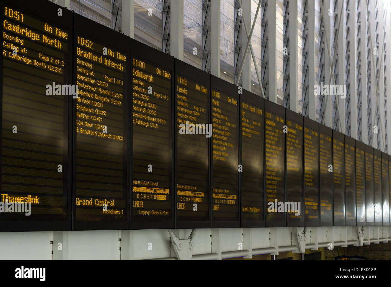 The main electronic information noticeboard in the main concourse of King's Cross station showing train information, London, UK Stock Photo