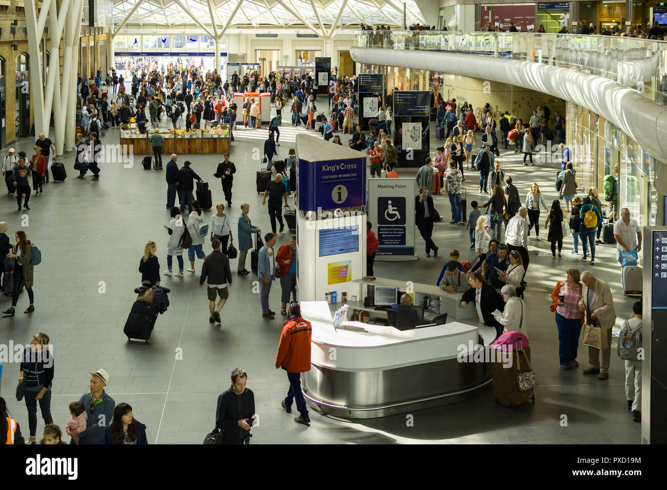 The main concourse of King's Cross station with passengers and ...