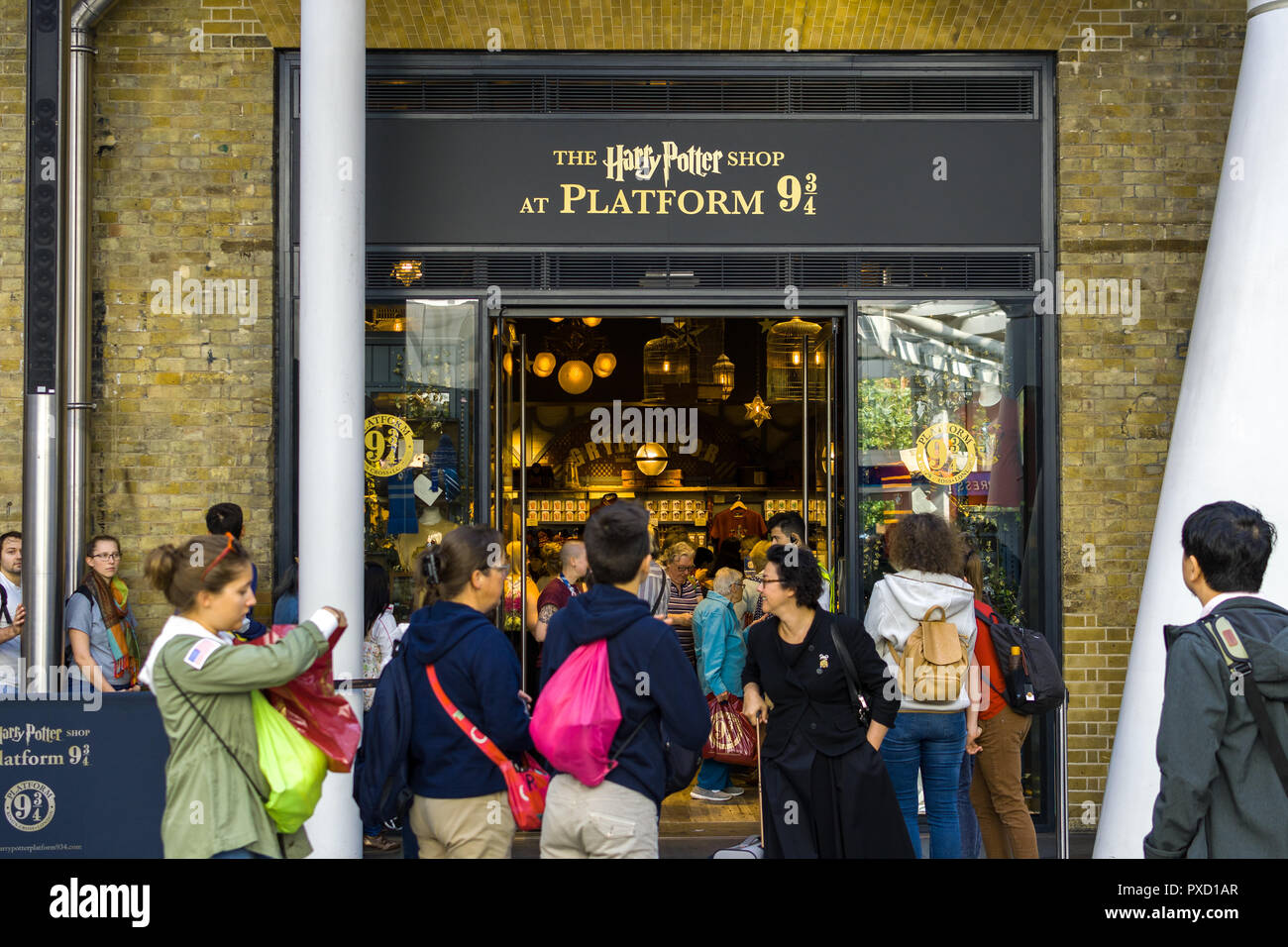 The Harry Potter Shop at Platform 9 ¾ Kings Cross Station entrance with shoppers browsing and queueing outside, London, UK Stock Photo