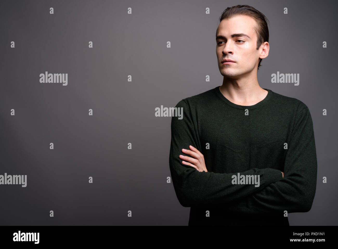 Young handsome man thinking and looking up with arms crossed Stock ...