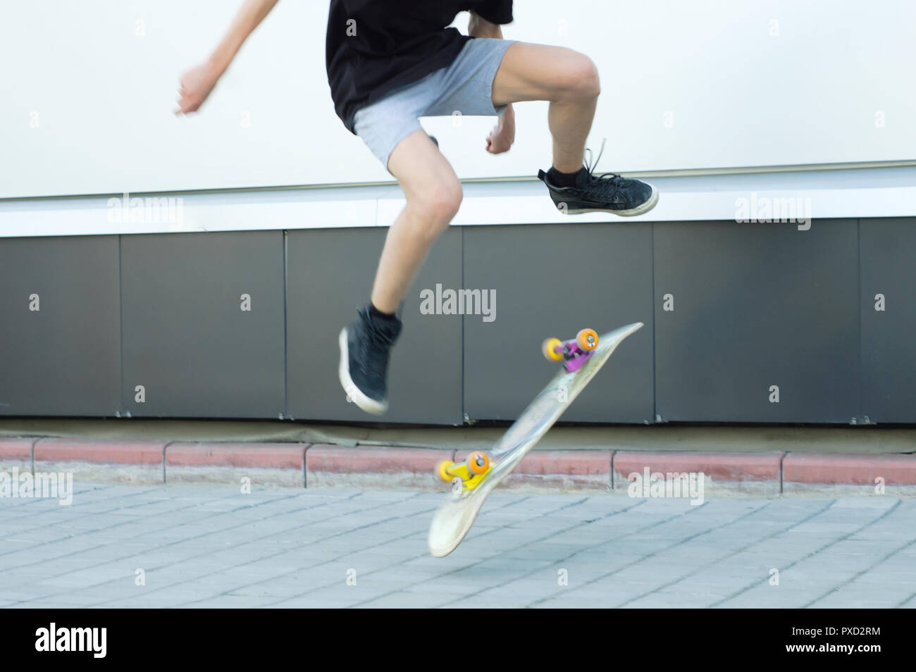 A guy is jumping on a skateboard up. Lubricated motion. Stock Photo