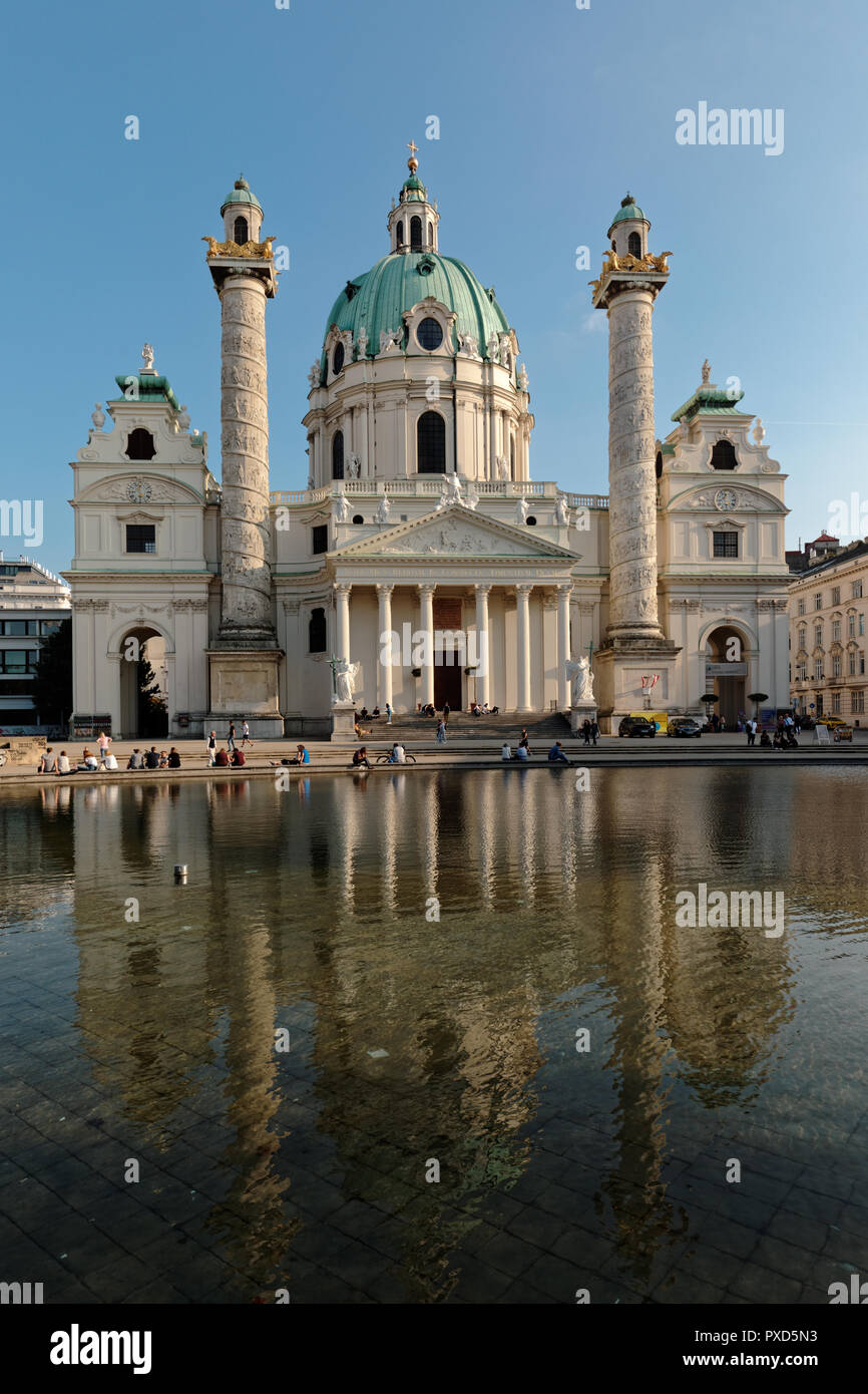 Vienna, Austria - September 16, 2018: People resting at the Karlskirche, St. Charles church in the center of Vienna. The church was consecrated in 173 Stock Photo