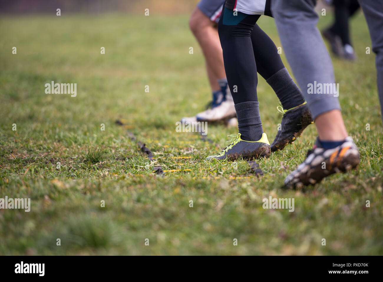 closeup of young american football team exercises on ladder drills at field Stock Photo