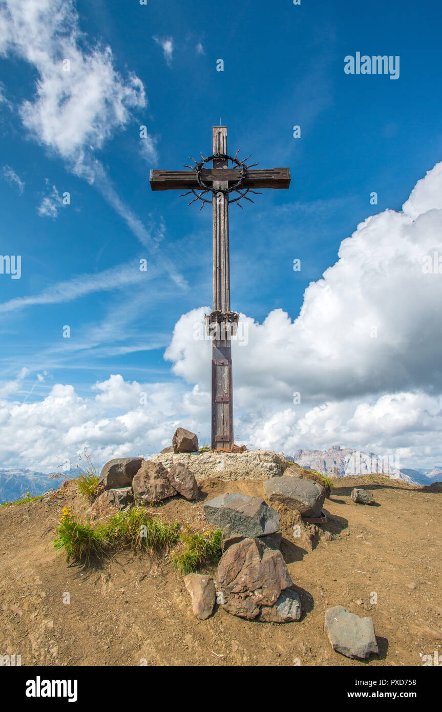 Summit cross, war memorial, wooden cross at the top of a mountain in Italy's Dolomites. Gorgeous summer day hiking in the mountains. Stock Photo
